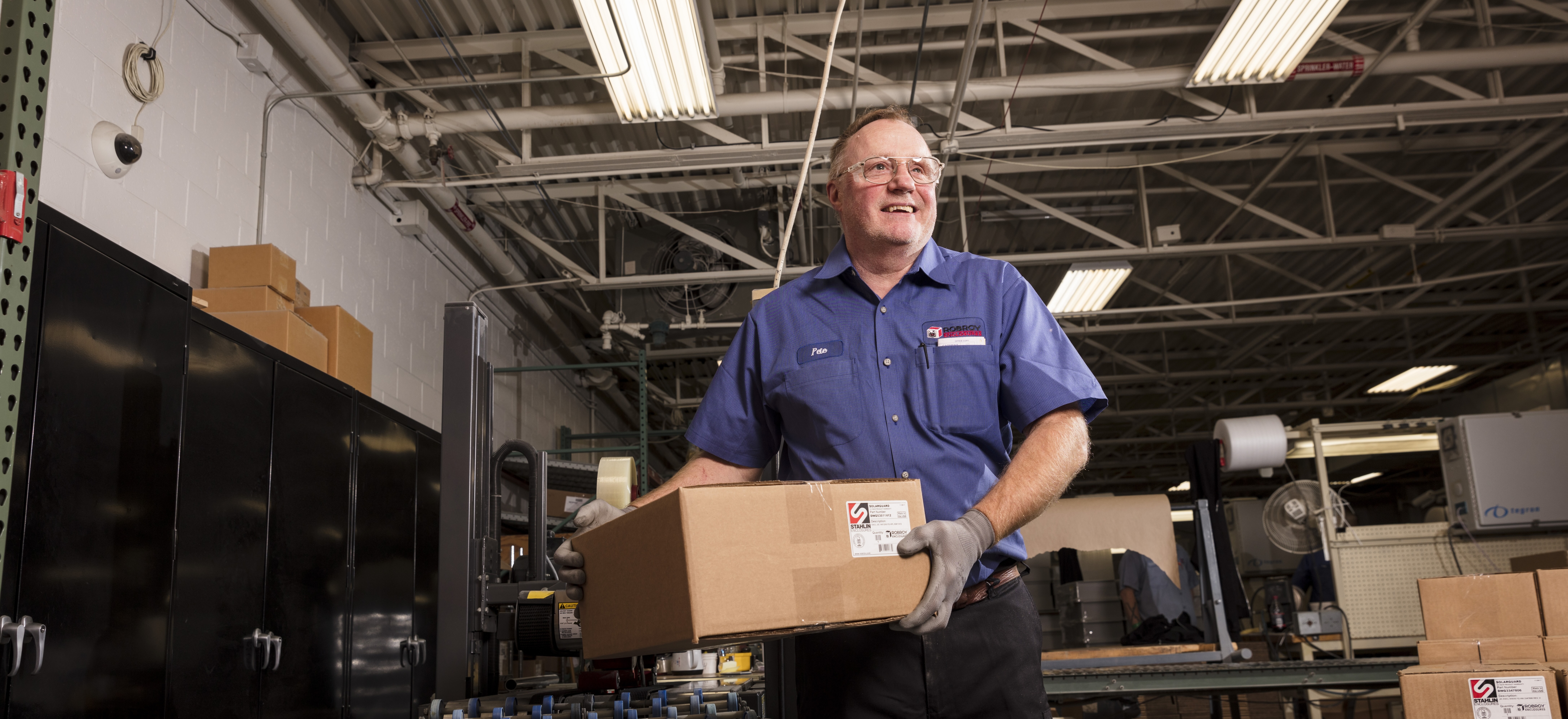 Robroy Employee handling Stahlin Enclosure package