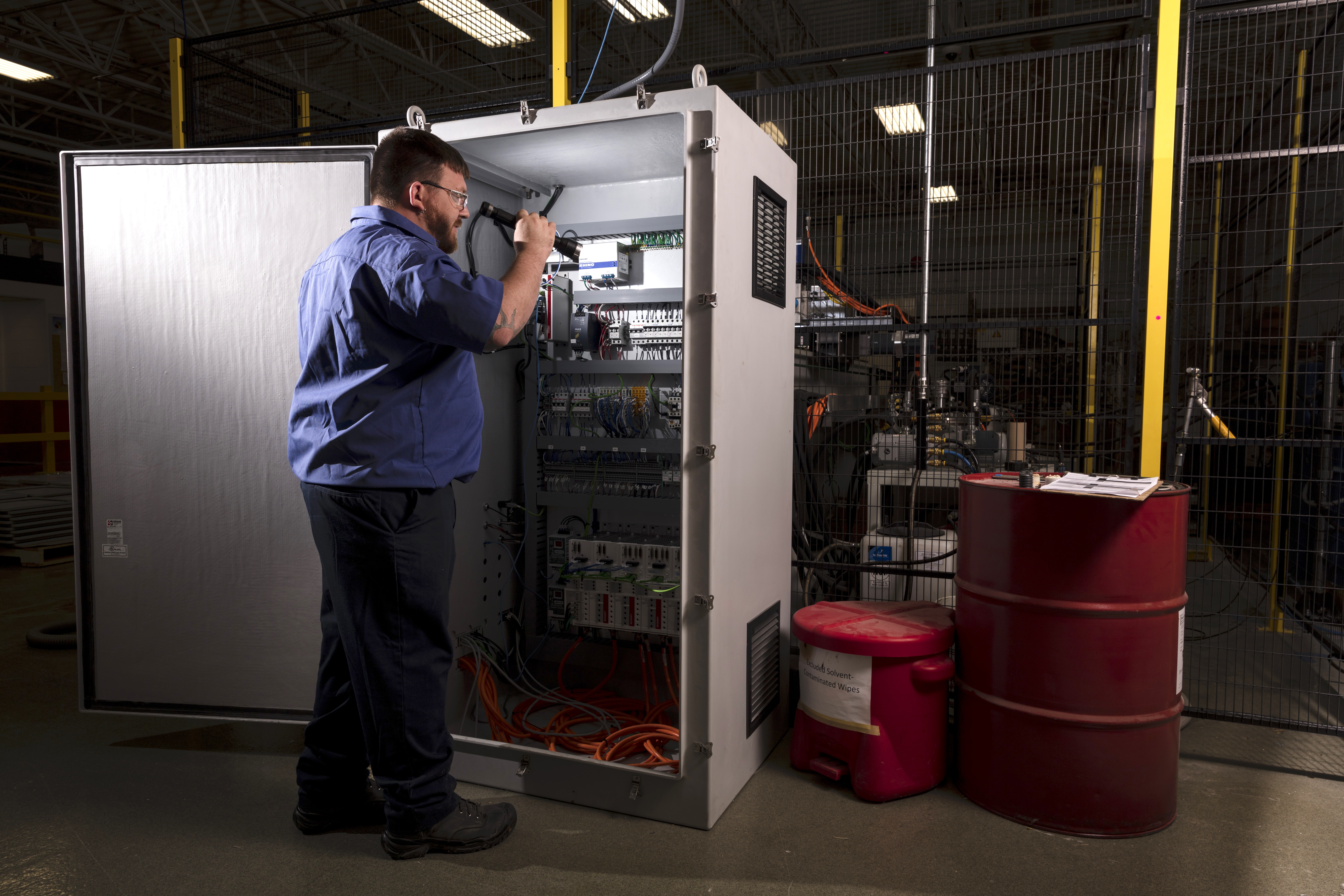 Robroy employee inspecting Stahlin enclosure interior
