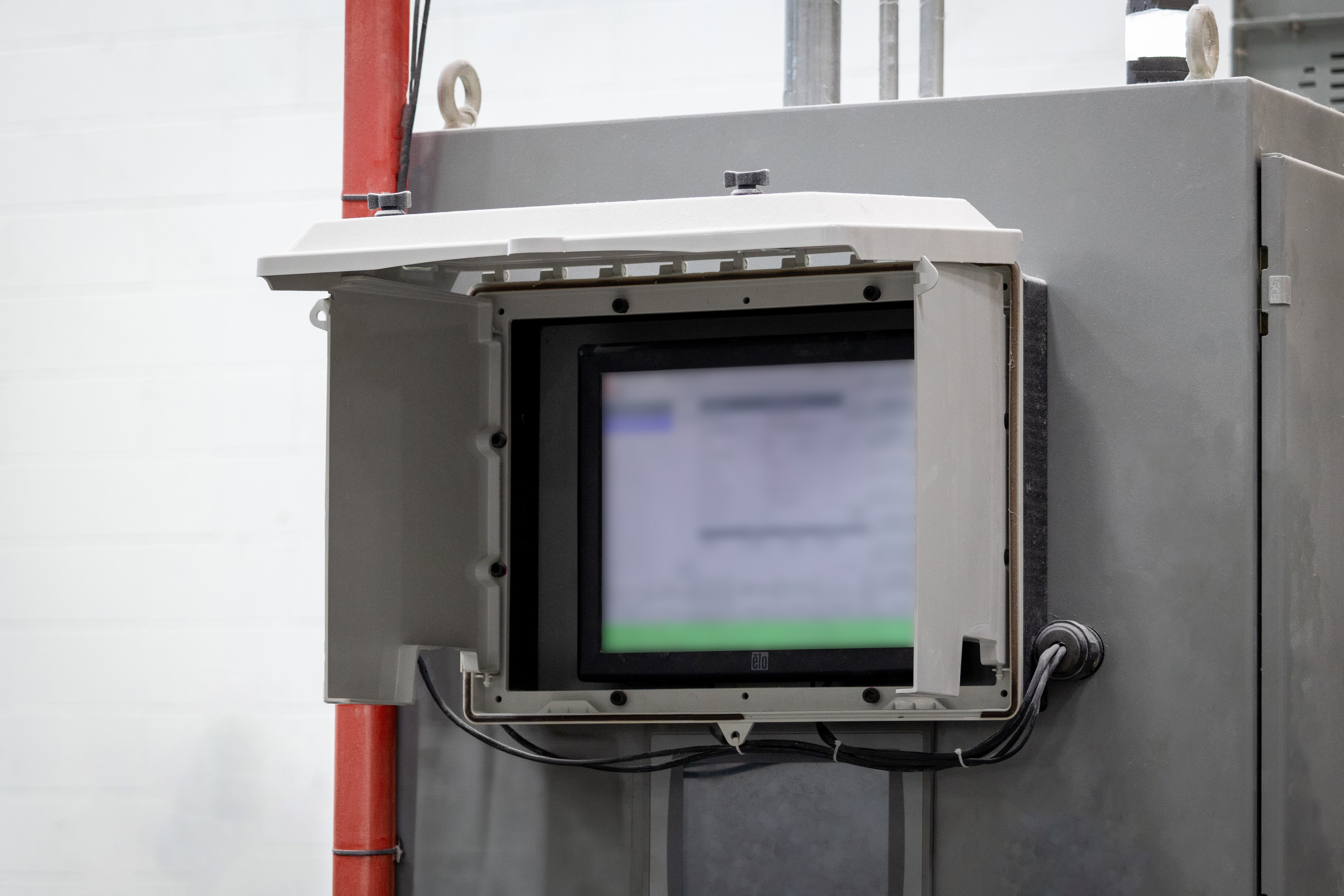 SolarShield HMI Cover by Robroy Stahlin in an open position shielding the HMI screen from the sun