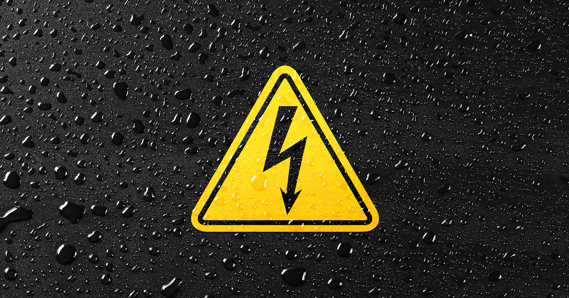 Black background with condensation and a yellow triangle with electrical warning 